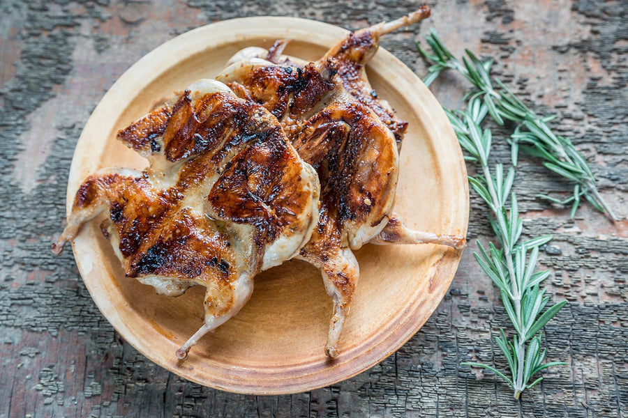 Char-grilled quail with a butter and thyme sauce